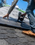 Roofer installing new shingles