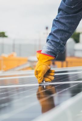Installer fitting rooftop solar panels